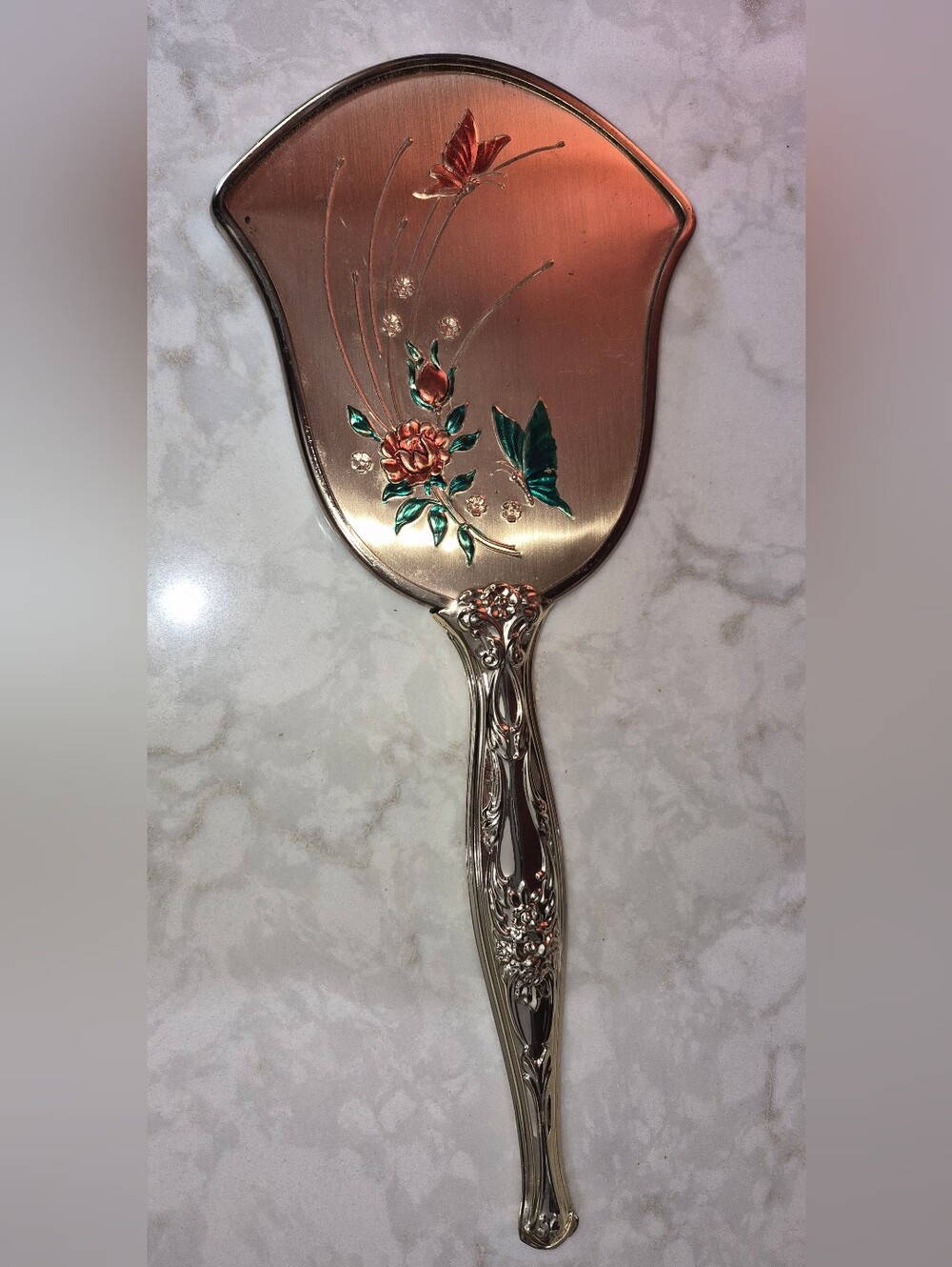 Vintage Gold-Tone Vanity hand mirror featuring an Ornate Embossed Handle